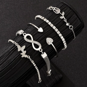 Detail of 5-piece silver bracelet set with butterfly, heart, and crystal charms