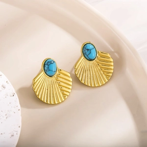 Detail showing vintage gold-plated fan-shaped earrings with textured turquoise stones