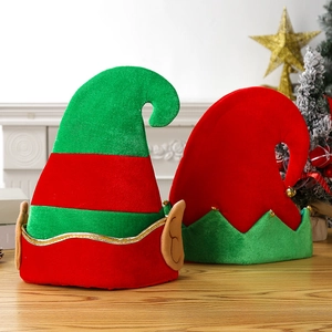 Funny Christmas elf hats with red and green stripes on a festive wooden tabletop scene