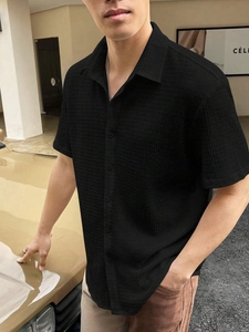 Detail of men's black short sleeve shirt featuring high-quality water ripple texture fabric