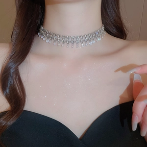Detail of silver tassel choker necklace with sparkling water-drop cubic zirconia stones