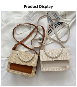 Detail of straw woven flap bags in brown and cream with elegant pearl handles