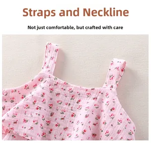 Detail of floral cotton baby girl dress shoulder strap and neckline with pleated texture