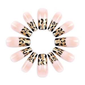 Long coffin leopard print gradient press-on nails with gold foil accents on white background