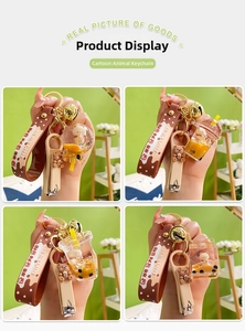 Detail of four creative acrylic milk tea bear keychains with golden bells and silicone straps
