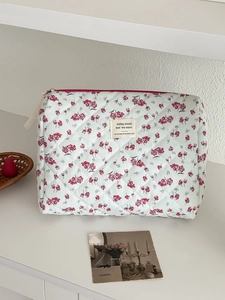 Quilted floral corduroy makeup bag in light blue with pink flowers and side handle