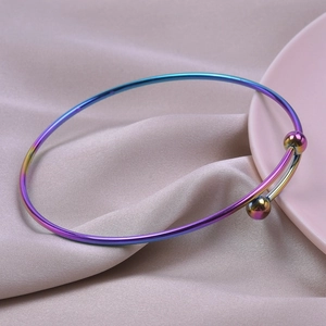 Detail view of iridescent rainbow titanium steel adjustable bracelet on silk background