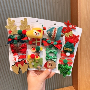 Christmas hair clip set for girls with reindeer, snowman and Santa Claus designs on card