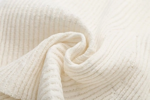Macro shot of white ribbed knit fabric texture showing soft material detail