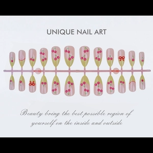 Detail view of 24pcs pink gradient press-on nails with cherry prints and red 3D bow knots