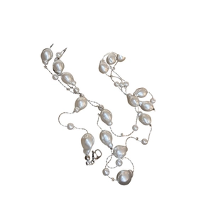 Layered baroque pearl sweater necklace with silver chain for women, white background