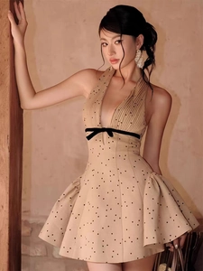 Detail of French V-neck dress with velvet polka dots and a black waist bow tie
