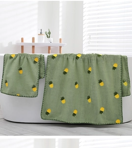 Close-up of fruit green coral fleece towel set with pineapple embroidery on bathtub