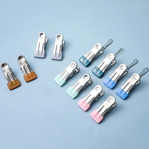 Colorful non-slip stainless steel laundry pegs and hook clips set on a blue surface