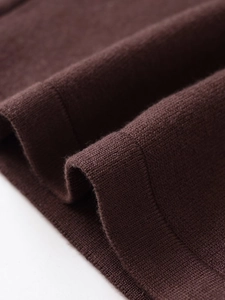 Macro shot of dark brown fine knit fabric showing soft texture and premium material detail