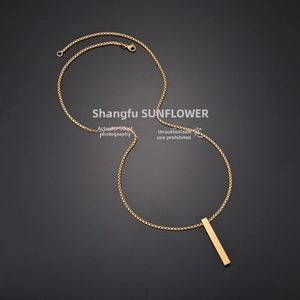 Detailed view of a minimalist gold box chain necklace with a solid rectangular bar pendant
