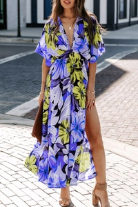 Detail of floral print maxi dress featuring deep V-neck and high side slit design