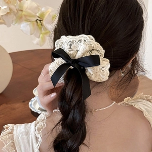 French retro lace scrunchie with double black bow tie worn on a braided hairstyle