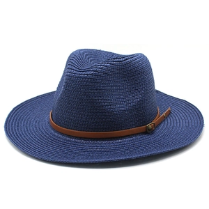 Detailed weave of navy straw Panama hat with brown leather band and bronze buckle