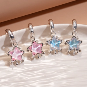 Star earrings with colorful crystals and silver tassels on a white ceramic plate