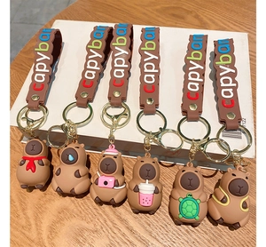 Detailed close-up of six unique cartoon capybara keychains with colorful silicone wrist straps