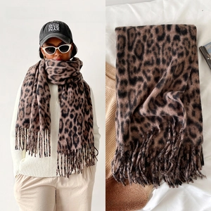Close-up of leopard print scarf featuring thick cashmere-like texture and fringed edges