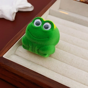 Cute green flocked frog jewelry box with 3D eyes on a premium wooden display tray