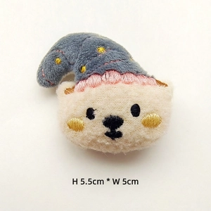 Detail of plush bear accessory with embroidery showing dimensions 5.5cm height by 5cm width