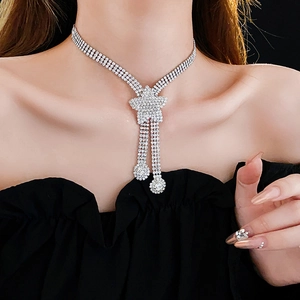 Detail of silver star pendant necklace with rhinestone tassels and matching ring