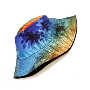 Detail of tropical palm tree print on bucket hat with vibrant sunset gradient colors