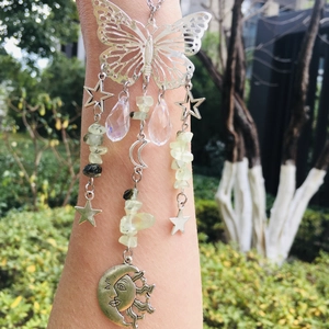 Macro view of butterfly and moon suncatcher with crystal beads and silver charms