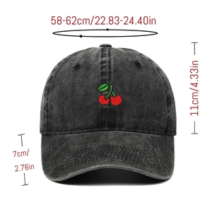 Detail view of washed denim baseball cap with cherry embroidery and size specifications