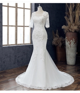 Detail eines Meerjungfrau-Hochzeitskleids mit Spitzenstickerei und transparenten Ärmeln