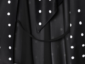 Detail of vintage black and white polka dot fabric showing texture and tie strap
