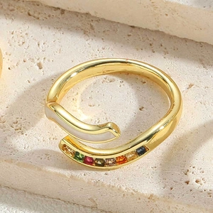 Detail of gold moon ring featuring colorful square gemstones and white mother of pearl
