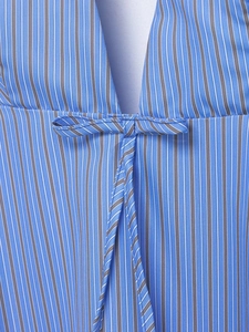 Detailed macro view of blue vertical striped woven fabric featuring a central bow tie design
