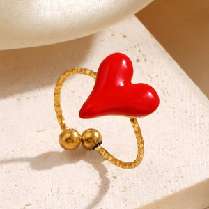 Minimalist gold stainless steel ring with a red enamel heart on a textured stone base