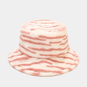 Close-up of soft pink and beige striped plush bucket hat with fluffy faux fur texture