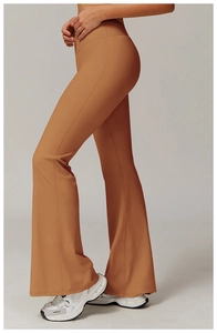 Side view of caramel flared yoga pants featuring high waist and reinforced side seams