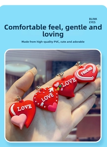 Detail of red PVC heart pendants with embossed white Love lettering and metal keyrings
