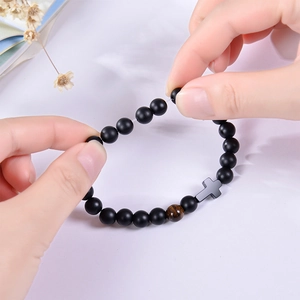 Handmade matte black onyx beaded bracelet with tiger eye stone and black cross pendant