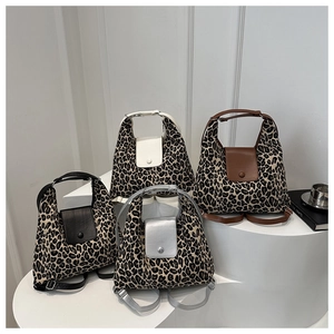 Macro view of leopard print tote bags in four colors on minimalist white pedestals