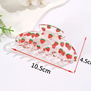 Detail showing 10.5cm transparent hair claw clip with a cute red strawberry print