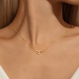 Close-up of minimalist gold S925 silver necklace with interlocking zircon double rings