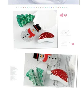 Detailed close-up of glittery Christmas tree, snowman and Santa hat hair claw clips set