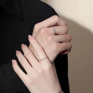 Cupid feather matching rings for couples in polished silver finish on model hands