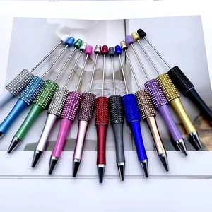 DIY rhinestone beaded ballpoint pens in multiple vibrant metallic colors fan arrangement