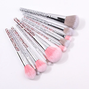 Detail of 10 makeup brushes with pink and silver crystals in clear handles