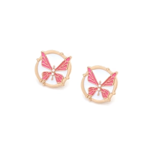 Close-up of pink enamel butterfly earrings with gold plating and pearl details