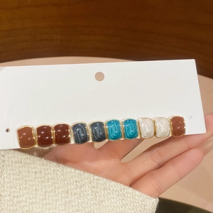Detail view of retro multi-color patchwork hair clip with high-gloss alloy glaze finish